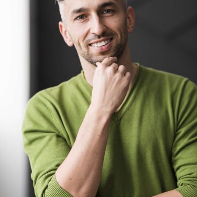 man-green-shirt-smiling-confident